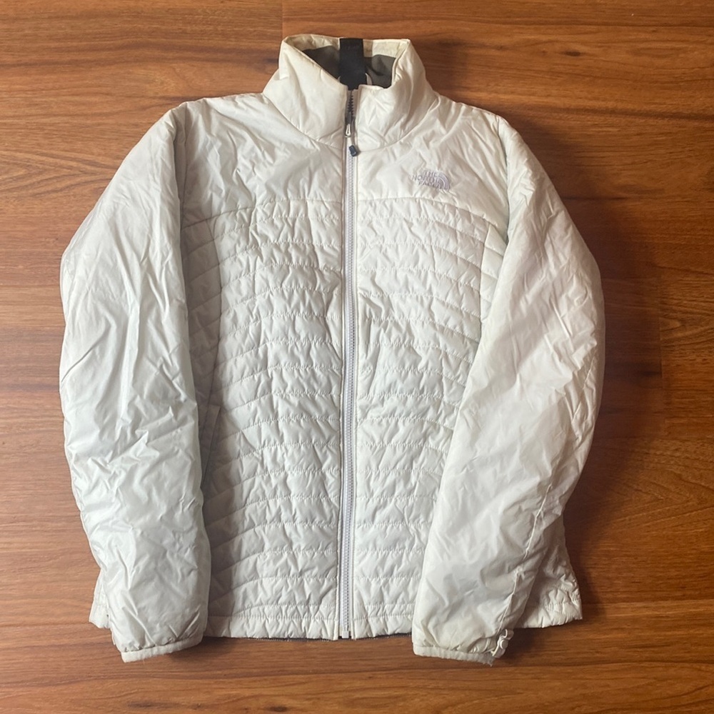 The North Face women’s large white zip up puffer jacket